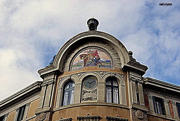 Building facade with mosaic and clock