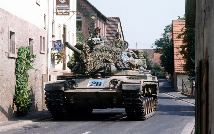 M60 Patton tank with crew in a European town