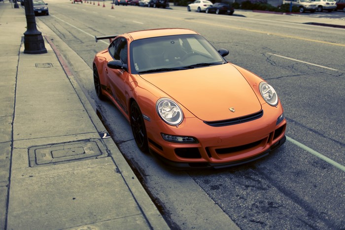 Orange Porsche 911 GT3 parked on a street