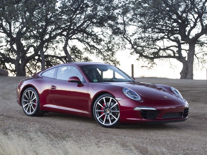 Red Porsche 911 parked on a dirt road