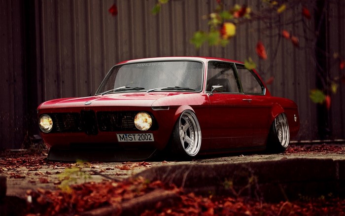 Red BMW 2002 with custom wheels