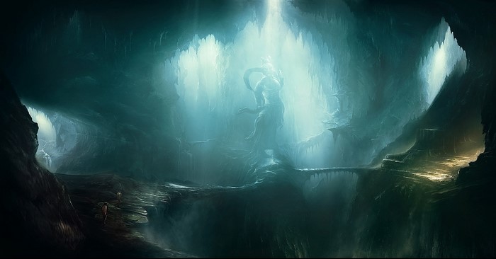 A statue in a glowing cave with a bridge