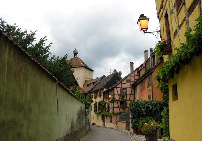 Street with traditional houses and tower in France