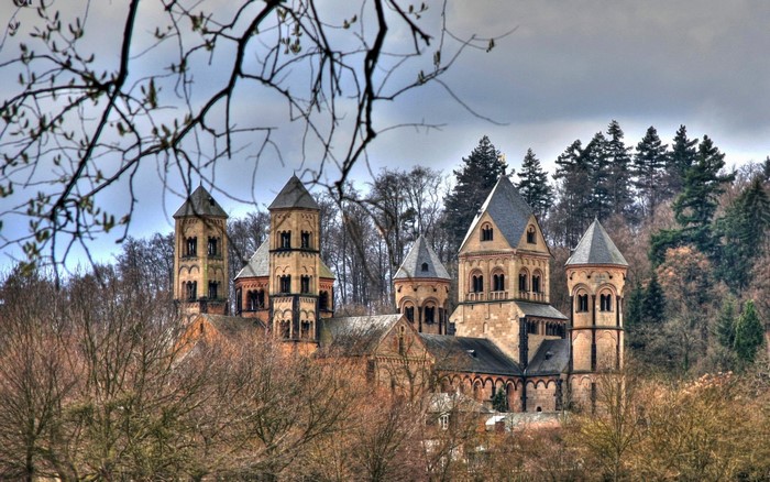 Romanesque Abbey church with towers in a forest