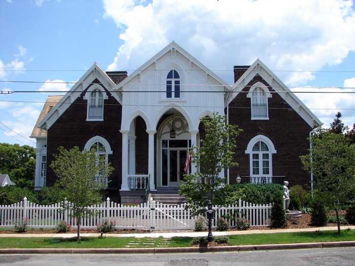 Gothic Revival house with white picket fence