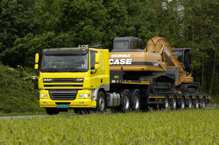 Yellow DAF CF truck carrying a CASE excavator