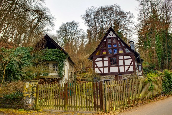 Two traditional German houses in a wooded area