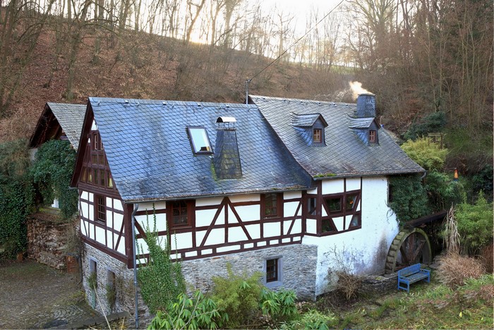 Half-timbered mill house in Germany with water wheel