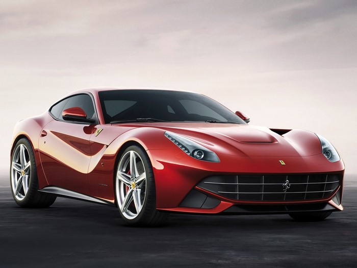Red Ferrari F12 Berlinetta parked on dark surface