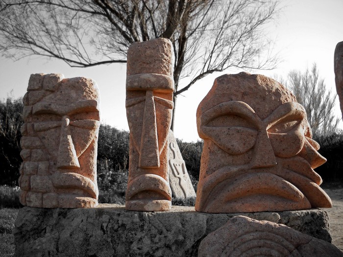 Stone sculptures of faces in a park