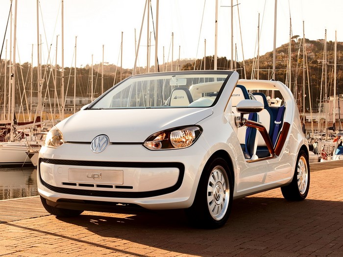 White Volkswagen up! convertible parked by a marina