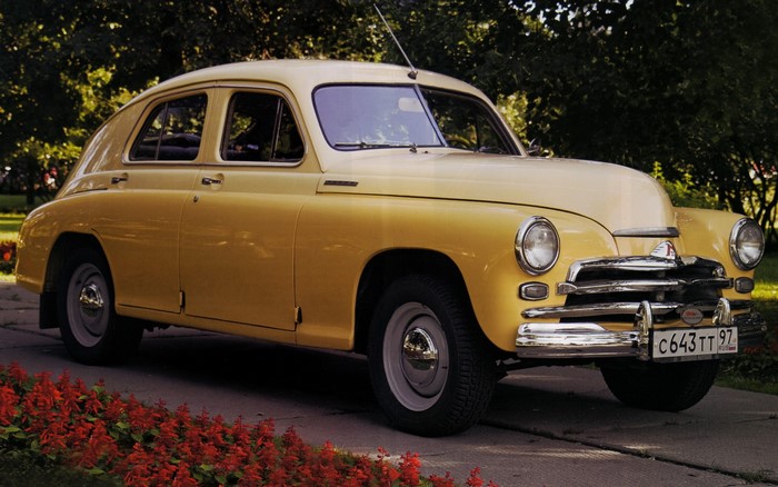 Yellow retro GAZ-21 Volga car parked outdoors
