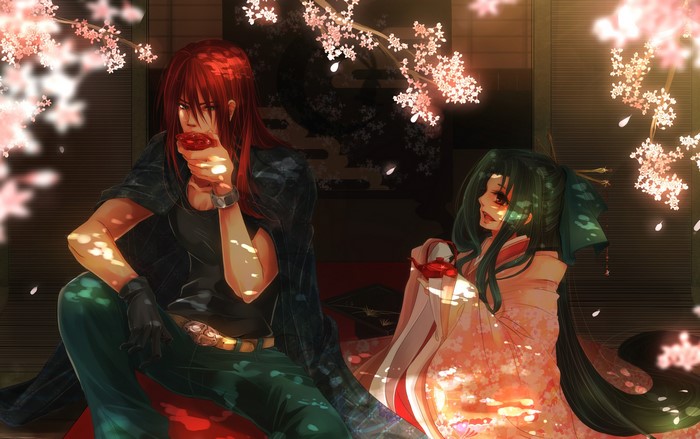 Man and woman drinking tea under cherry blossoms