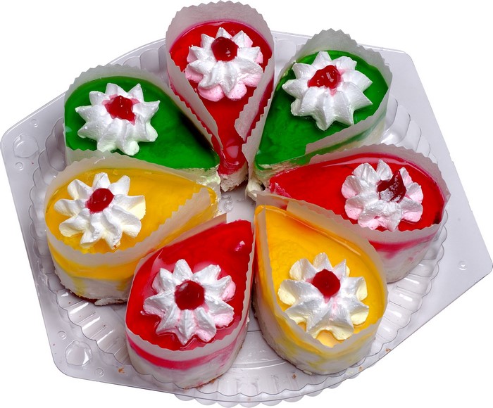 Assortment of colorful mini cakes in a plastic tray