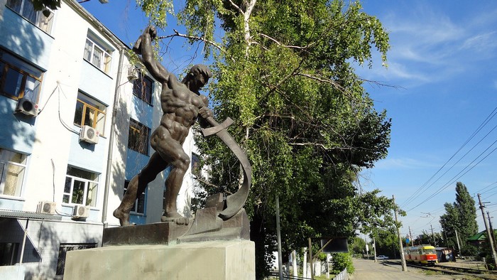 Monument of a muscular man with a scythe in Volgograd