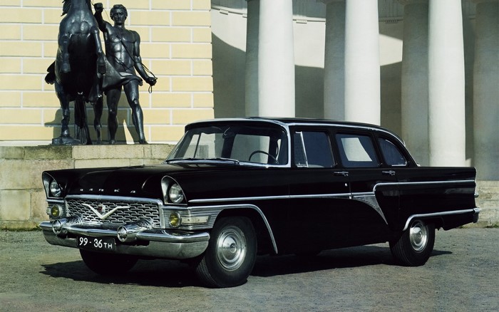 Black GAZ-13 Chaika car in front of a building