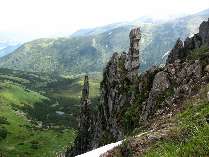 Rocky mountain peaks overlooking a green valley