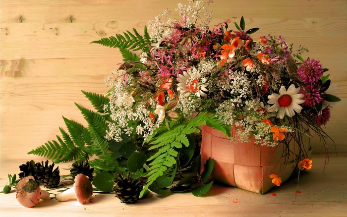 Bouquet of wildflowers and ferns in a basket
