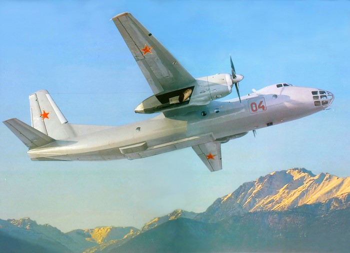 Antonov An-12BK airplane flying over mountains