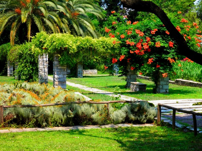 Stone pergolas and blooming trees in a park
