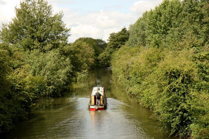Boat on a canal surrounded by trees