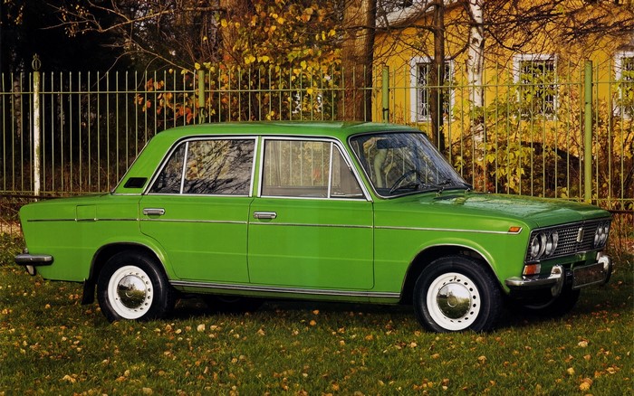 Green Russian sedan car parked on grass
