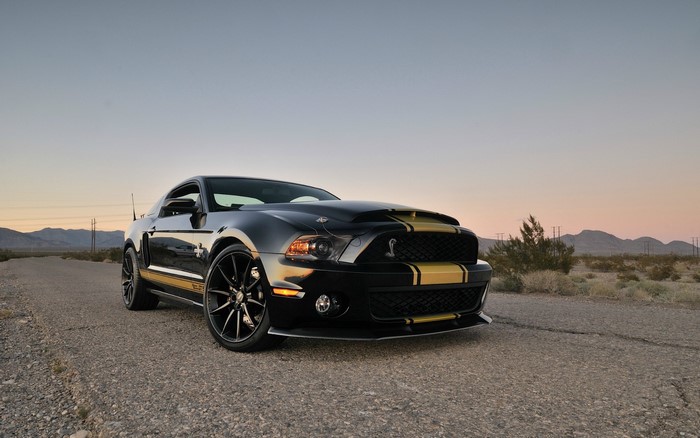 Black Ford Mustang Shelby GT500 on a desert road