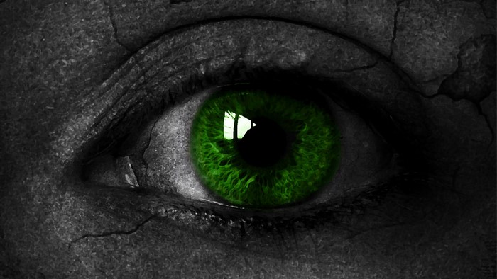 Close-up of a green eye with cracked skin texture