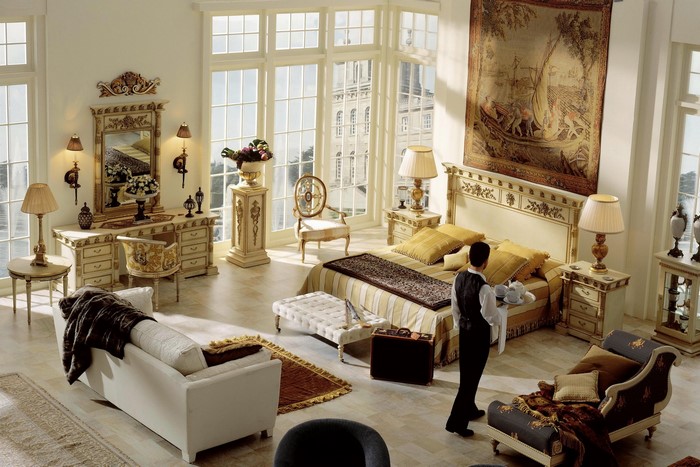Elegant bedroom with a man serving tea