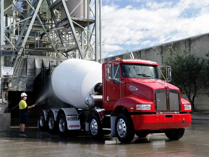 Red Kenworth cement mixer truck being washed