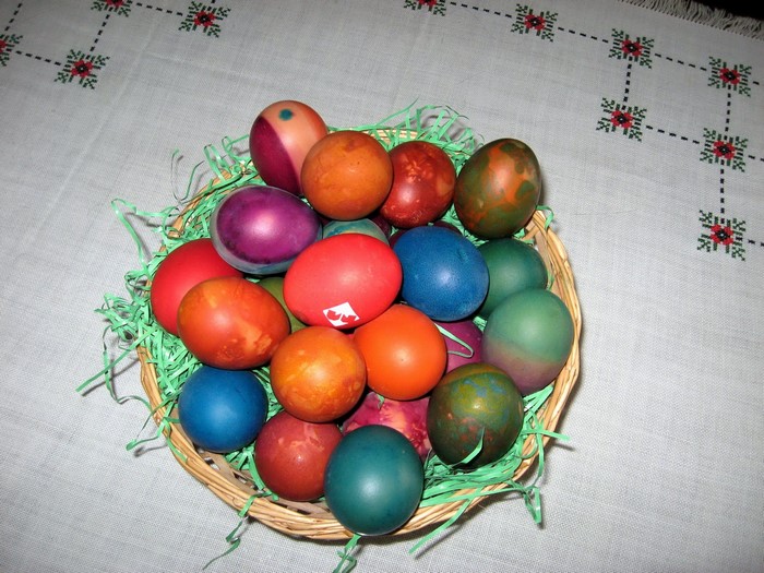 Easter eggs in a basket on a tablecloth
