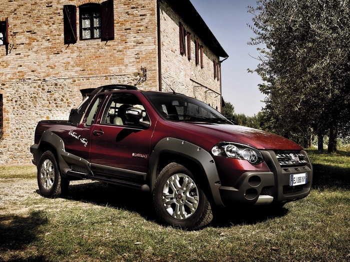 Fiat Strada pickup truck parked in front of a brick building