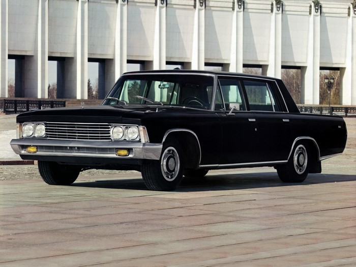 Black GAZ-13 Chaika limousine in front of a building