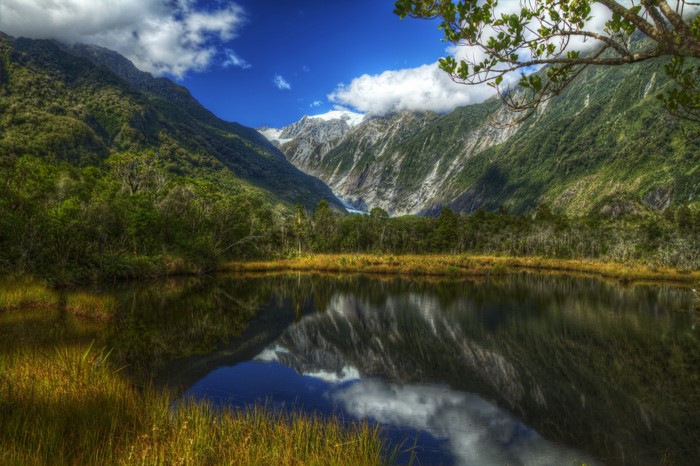 Lake reflecting mountains and trees in a valley