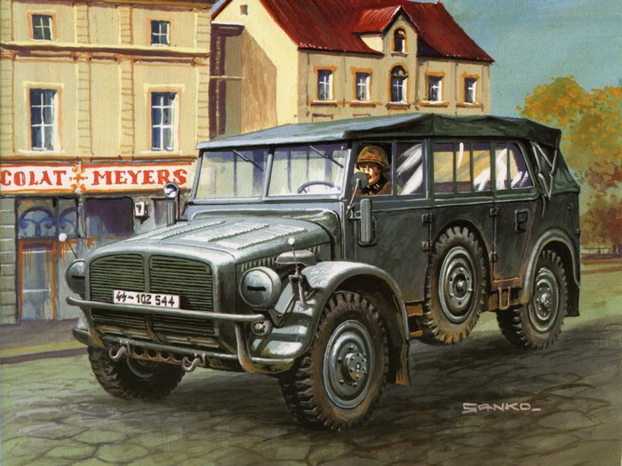 German military vehicle with driver in front of buildings