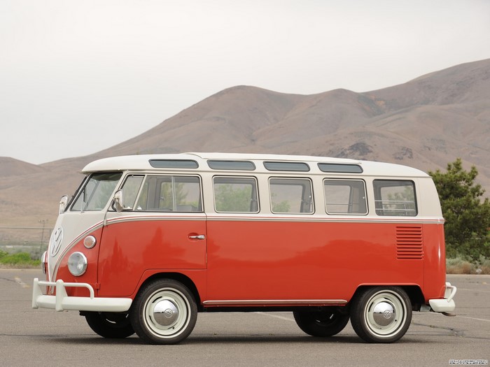 Red and white Volkswagen T1 Deluxe Microbus parked outdoors