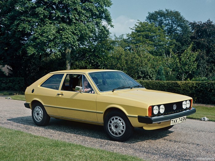 Yellow Volkswagen Scirocco parked on a gravel driveway