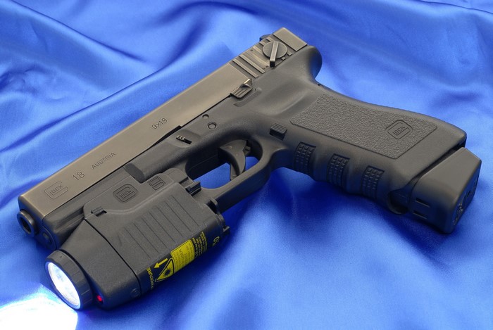 Glock 18 pistol with laser sight