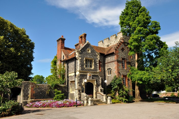 Stone and brick house with crenellated tower in the UK