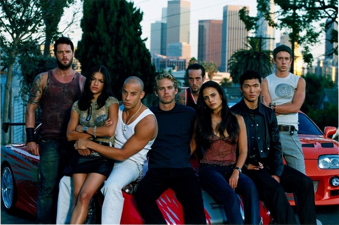 The Fast and the Furious cast posing by a car