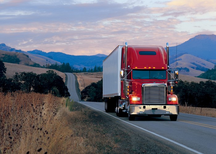 Red Freightliner Truck on a Winding Road