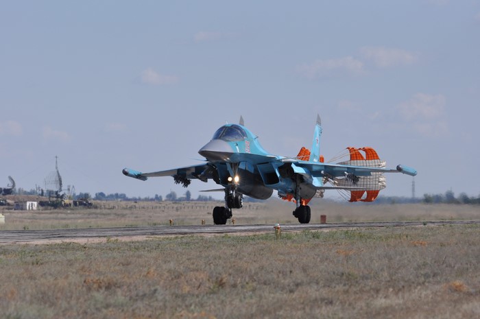Sukhoi Su-34 fighter jet landing with parachute