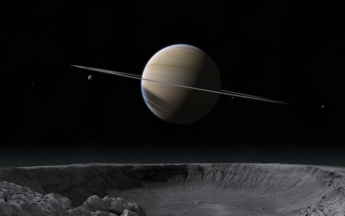 Saturn and its moons from a cratered surface