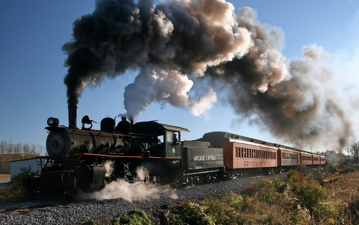 Steam Locomotive with Passenger Cars Emitting Smoke