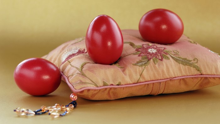 Red Easter Eggs on a Decorative Pillow