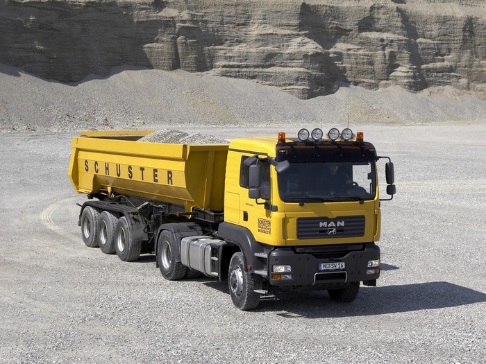 Yellow MAN dump truck with SCHUSTER logo