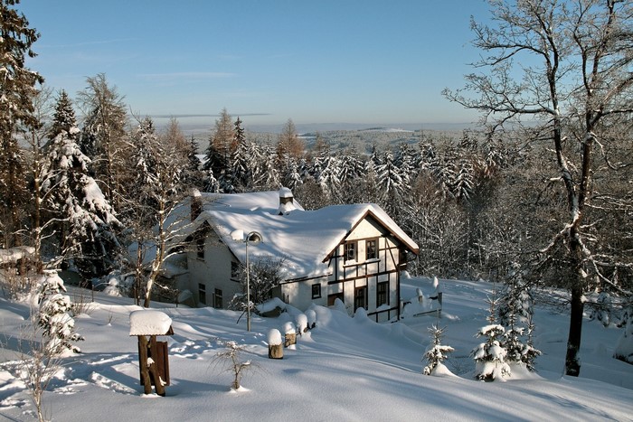 Snow-covered house in Czech Republic forest