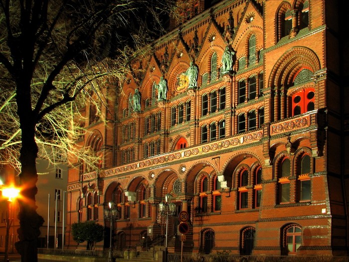 Brick building with arched windows at night in Germany