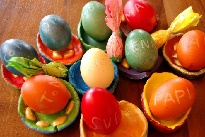 Easter eggs with names on wooden table