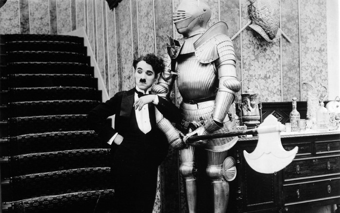 Charlie Chaplin with a suit of armor